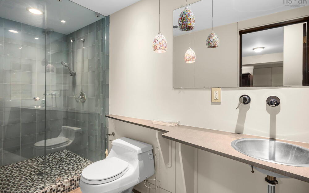 Full bathroom with toilet, a shower stall, vanity, and recessed lighting