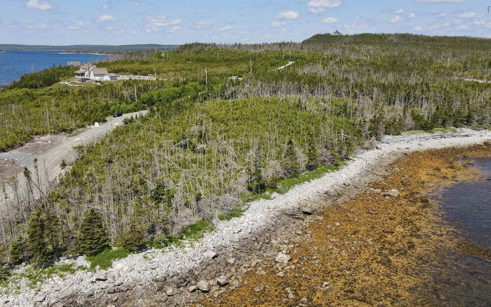 Aerial view of property's location featuring a large body of water